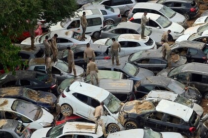 Soldiers search wrecked cars damaged by flooding in Massassana. (AFP) Soldiers search wrecked cars damaged by flooding in Massassana. (AFP)