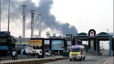 An ambulance moves as smoke billows from the Indian Oil Corporation’s Gujarat Refinery at Koyali in Vadodara on Monday. (REUTERS) An ambulance moves as smoke billows from the Indian Oil Corporation’s Gujarat Refinery at Koyali in Vadodara on Monday. (REUTERS)