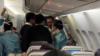 A brazen flight passenger had to be restrained after he tried to open the emergency door mid-air. (Instagram)