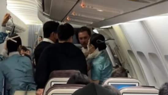 A brazen flight passenger had to be restrained after he tried to open the emergency door mid-air. (Instagram)
