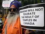 A Nihang Sikh warrior holds a placard as he takes part in a protest near the Canadian embassy in New Delhi on November 10 against the recent attack on a Hindu temple in the city of Brampton, (AFP)