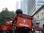 Swiggy Ltd. delivery workers on motorcycles outside a company's dark store in Mumbai. Swiggy Ltd. delivery workers on motorcycles outside a company's dark store in Mumbai.