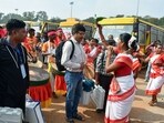 Tribal women perform well wishing for the polling officials prior to the departure for the election duty on the eve of first phase of Jharkhand Assembly elections, at Morabadi Football ground, in Ranchi on Tuesday.