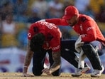 England's wicket keeper Phil Salt tends to Reece Topley after he fell bowling against West Indies during the first T20 cricket match at Kensington Oval in Bridgetown, Barbados England's wicket keeper Phil Salt tends to Reece Topley after he fell bowling against West Indies during the first T20 cricket match at Kensington Oval in Bridgetown, Barbados