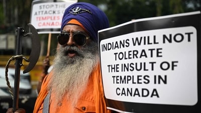 A Nihang Sikh warrior holds a placard as he takes part in a protest near the Canadian embassy in New Delhi on November 10 against the recent attack on a Hindu temple in the city of Brampton, (AFP) (AFP) A Nihang Sikh warrior holds a placard as he takes part in a protest near the Canadian embassy in New Delhi on November 10 against the recent attack on a Hindu temple in the city of Brampton, (AFP) (AFP)