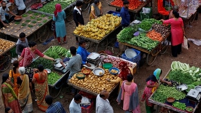 Customers buy fruit and vegetables at an open air evening market in Ahmedabad, India, August 21, 2023. (Amit Dave/Reuters)
