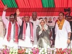 Samajwadi Party chief Akhilesh Yadav with the party's Sisamau assembly constituency bye-election candidate Naseem Solanki.