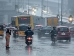 Commuters ride along a street amid rainfall in Chennai on November 12, 2024. Commuters ride along a street amid rainfall in Chennai on November 12, 2024.