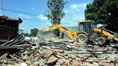 A bulldozer being used to demolish the bakery of Moid Khan who is accused of allegedly raping a 12-year-old girl, in Ayodhya. (File image) A bulldozer being used to demolish the bakery of Moid Khan who is accused of allegedly raping a 12-year-old girl, in Ayodhya. (File image)