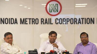 Executive director of NMRC Mahendra Prasad (centre) addressing a press conference on Wednesday regarding Noida Metro’s plans to lease out its commercial properties along Aqua Line in order to raise funds. (HT Photo)