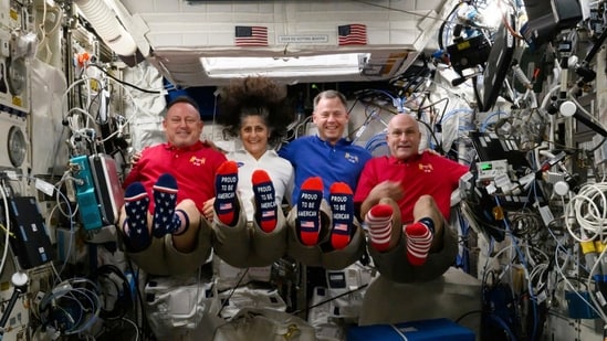 In this photo provided by NASA, from left, astronauts Butch Wilmore, Suni Williams, Nick Hague and Don Pettit show their U.S. flag-themed socks aboard the International Space Station on Election Day, Tuesday, Nov. 5, 2024. (AP)