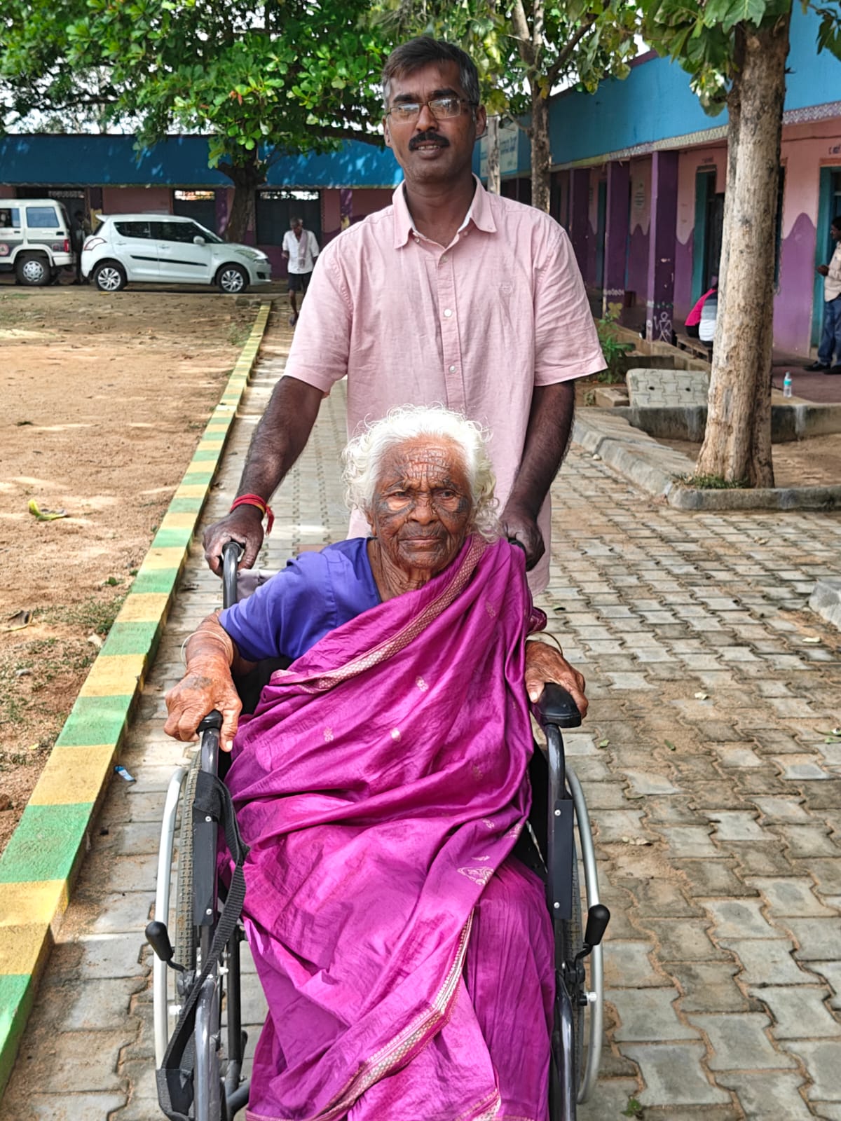 A senior citizen arrives at a polling station in Karnataka on Wednesday.