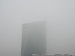 A metro runs braves through smog-induced low visibility at Cyber City metro station near DLF Gateway Tower on Wednesday, when Gurugram air quality index (AQI) dropped to “very poor” levels, logging a reading of 321. (Parveen Kumar/HT Photo)