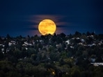 The biggest and brightest supermoon of the year, known as the Hunter's Moon, rises above a neighborhood, Thursday, Oct. 17, 2024, in Colorado Springs, Colo. 