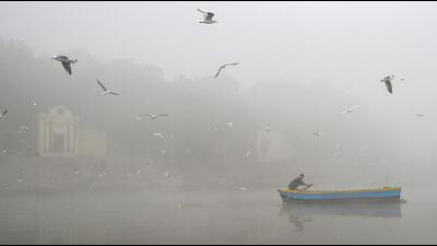 A man rows a boat in the Yamuna engulfed in smog in New Delhi on November 14. (AFP) A man rows a boat in the Yamuna engulfed in smog in New Delhi on November 14. (AFP)