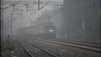 A train coming from Garhi Harsaru station to the Gurugram station amid morning smog near Rajendra Park in Gurugram on Thursday. (Parveen Kumar/HT Photo) A train coming from Garhi Harsaru station to the Gurugram station amid morning smog near Rajendra Park in Gurugram on Thursday. (Parveen Kumar/HT Photo)