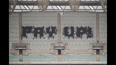 Activists with signs spell out "pay up" for climate finance in the Baku Olympic Stadium during the COP29 U.N. Climate Summit, Thursday, Nov. 14, 2024, in Baku, Azerbaijan. (AP Photo/Sergei Grits) (AP)