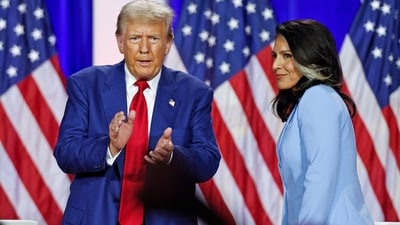 Donald Trump claps as he leaves the stage after speaking alongside former US Representative Tulsi Gabbard. (AFP)