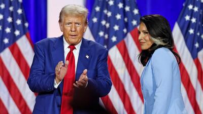 Former US President and Republican presidential candidate Donald Trump (left) claps as he leaves the stage after speaking alongside former US Representative Tulsi Gabbard during a town hall meeting in La Crosse, Wisconsin, on August 29. (AFP)