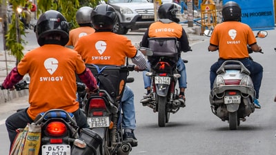 In this Tuesday, file photo, deliverymen of food aggregators Swiggy ride their bikes towards their destinations, in New Delhi. (PTI) In this Tuesday, file photo, deliverymen of food aggregators Swiggy ride their bikes towards their destinations, in New Delhi. (PTI)