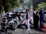 People gather around the car that got mangled after it got hit by a container, in Dehradun on Monday. At least six people were killed and one other was injured in the accident. (ANI Photo) People gather around the car that got mangled after it got hit by a container, in Dehradun on Monday. At least six people were killed and one other was injured in the accident. (ANI Photo)