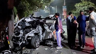 People gather around the car that got mangled after it hit a container, in Dehradun on Monday. (ANI) People gather around the car that got mangled after it hit a container, in Dehradun on Monday. (ANI)