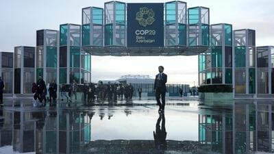 Attendees arrive for the day at the COP29 UN Climate Summit on November 14 in Baku, Azerbaijan. (AP) Attendees arrive for the day at the COP29 UN Climate Summit on November 14 in Baku, Azerbaijan. (AP)