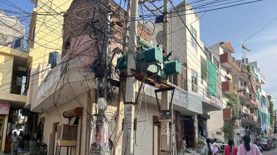 Electricity poles in a residential area in Gurugram. (HT Archive)