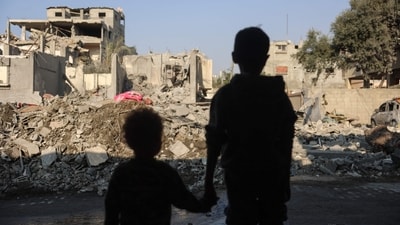 TOPSHOT - Children stare at the destruction following an Israeli strike in the Nuseirat refugee camp in the central Gaza Strip on November 7, 2024, amid the ongoing war between Israel and Palestinian Hamas militants. (Photo by Eyad BABA / AFP) TOPSHOT - Children stare at the destruction following an Israeli strike in the Nuseirat refugee camp in the central Gaza Strip on November 7, 2024, amid the ongoing war between Israel and Palestinian Hamas militants. (Photo by Eyad BABA / AFP)