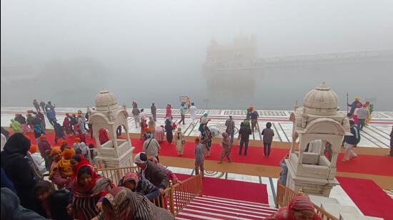 Devotees at the Golden Temple in Amritsar on the occasion of the Prakash Purb of Guru Nanak Dev on Friday. Amritsar recorded an air quality index of 225 in the morning. (Sameer Sehgal/HT)