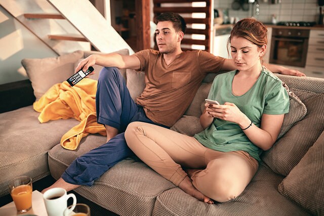 Scrolling on your phone when you’re watching a show with someone is a polarising activity. (Adobe stock) Scrolling on your phone when you’re watching a show with someone is a polarising activity. (Adobe stock)