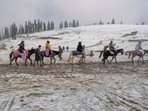 Gulmarg: Tourists take a pony ride after the season's first snowfall Gulmarg: Tourists take a pony ride after the season's first snowfall