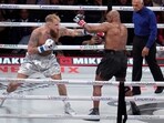 Jake Paul, left, fights Mike Tyson during their heavyweight boxing match, Friday, Nov. 15, 2024, in Arlington, Texas. (AP Photo/Julio Cortez)