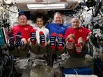 In this photo provided by NASA, from left, astronauts Butch Wilmore, Suni Williams, Nick Hague and Don Pettit show their U.S. flag-themed socks aboard the International Space Station on Election Day, Tuesday, Nov. 5, 2024. In this photo provided by NASA, from left, astronauts Butch Wilmore, Suni Williams, Nick Hague and Don Pettit show their U.S. flag-themed socks aboard the International Space Station on Election Day, Tuesday, Nov. 5, 2024.