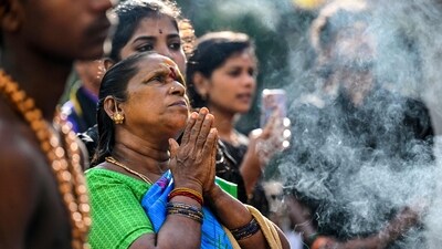 Devotees offer prayers at the onset of a holy month ahead of their pilgrimage to the Sabarimala shrine (AFP) Devotees offer prayers at the onset of a holy month ahead of their pilgrimage to the Sabarimala shrine (AFP)