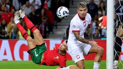 Portugal's Cristiano Ronaldo, left, scores his side's fifth goal with an overhead kick during the UEFA Nations League soccer match between Portugal and Poland at the Dragao stadium in Porto, Portugal. (AP) Portugal's Cristiano Ronaldo, left, scores his side's fifth goal with an overhead kick during the UEFA Nations League soccer match between Portugal and Poland at the Dragao stadium in Porto, Portugal. (AP)