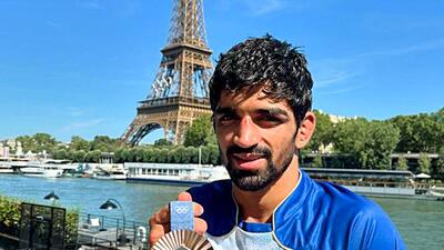 Wrestler Aman Sehrawat poses with the medal in front of the Eiffel Tower during Paris Olympics. (Doordarshan Sports-X) Wrestler Aman Sehrawat poses with the medal in front of the Eiffel Tower during Paris Olympics. (Doordarshan Sports-X)