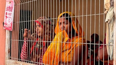 Seeking answers, family members were seen waiting outside the Maharani Laxmi Bai Medical college. (PTI) Seeking answers, family members were seen waiting outside the Maharani Laxmi Bai Medical college. (PTI)