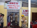 Firefighters work after a fire broke out in a neonatal intensive care unit at Jhansi Medical College hospital, in Jhansi.