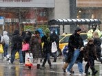 FILE PHOTO: Holiday shoppers carry their packages, as they walk down Michigan Avenue, during heavy snowfall, in Chicago December 24, 2010. REUTERS/Frank Polich/File Photo