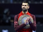 Serbia's Novak Djokovic applauds with a trophy. Serbia's Novak Djokovic applauds with a trophy.