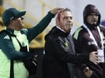 Mexico's coach, Javier Aguirre (R), is helped by an assistant after being injured in the head. Mexico's coach, Javier Aguirre (R), is helped by an assistant after being injured in the head.