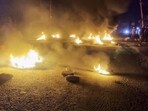 Tyres set on fire by people protesting after bodies of six people from the Meitei community were found, days after they were taken hostage by suspected Kuki insurgents from Manipur's Jiribam district, Saturday night. (PTI) Tyres set on fire by people protesting after bodies of six people from the Meitei community were found, days after they were taken hostage by suspected Kuki insurgents from Manipur's Jiribam district, Saturday night. (PTI)