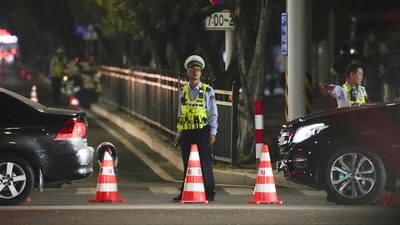 A security personnel stands guard near a sports center where a man rammed a car into people exercising in Zhuhai, China on Monday. (AP) A security personnel stands guard near a sports center where a man rammed a car into people exercising in Zhuhai, China on Monday. (AP)