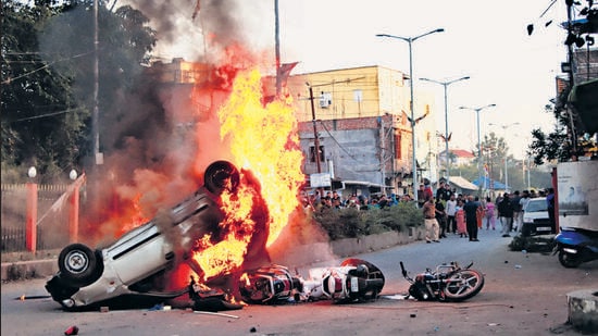 Smoke and flames billow out of vehicles which were set on fire during demonstrations after three bodies, suspected to be of six missing persons from Jiribam district, were found near the Manipur-Assam border on Friday night, in Imphal, on Saturday. (PTI)