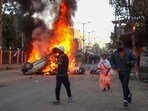 People run past burning vehicles of India's Bharatiya Janata Party (BJP) MLA during a protest to condemn the alleged killing of women and children in Imphal, capital of India's violence-hit northeastern state of Manipur on November 16, 2024. (Photo by AFP) People run past burning vehicles of India's Bharatiya Janata Party (BJP) MLA during a protest to condemn the alleged killing of women and children in Imphal, capital of India's violence-hit northeastern state of Manipur on November 16, 2024. (Photo by AFP)