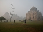 Men play badminton at Lodhi Garden while the sky is enveloped with smog.
