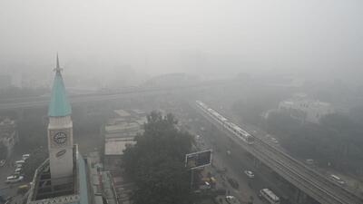 A Metro train passes amid thick layers of smog at Sikandarpur Metro station near DLF City court in Gurugram on Monday. (Parveen Kumar/HT Photo)