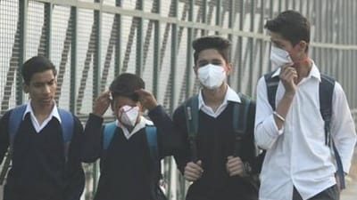 Children walk to school wearing face masks to protect themselves from air pollution in Delhi. Children walk to school wearing face masks to protect themselves from air pollution in Delhi.