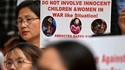 Activists and supporters of Women's Wing Delhi Meetei Co-ordinating Committee (DMCC) and Manipur Students' Association Delhi (MSAD) hold placards during a protest in New Delhi (AFP) Activists and supporters of Women's Wing Delhi Meetei Co-ordinating Committee (DMCC) and Manipur Students' Association Delhi (MSAD) hold placards during a protest in New Delhi (AFP)